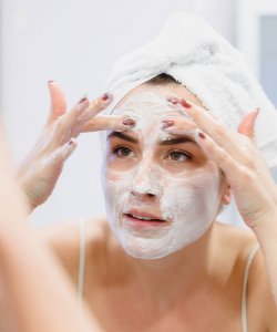 Woman cleansing her face Cleanser for oily skin and acne prone skin